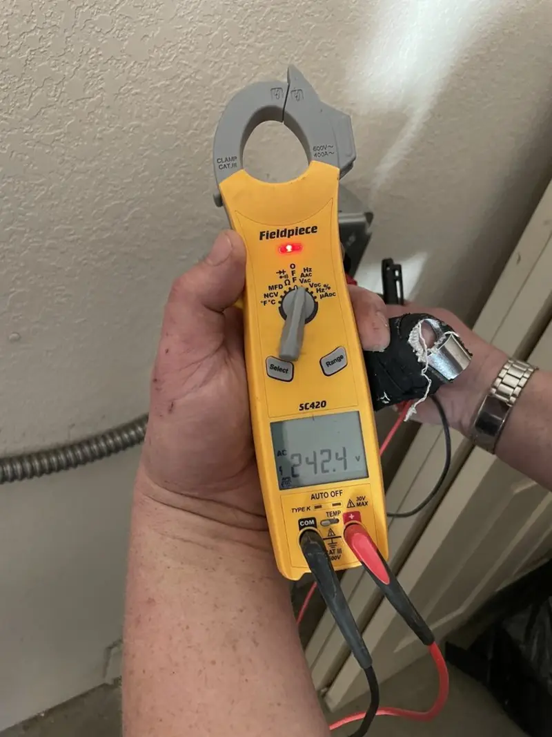 Voltage testing with clamp meter during Electrical Installation Services in Waukon